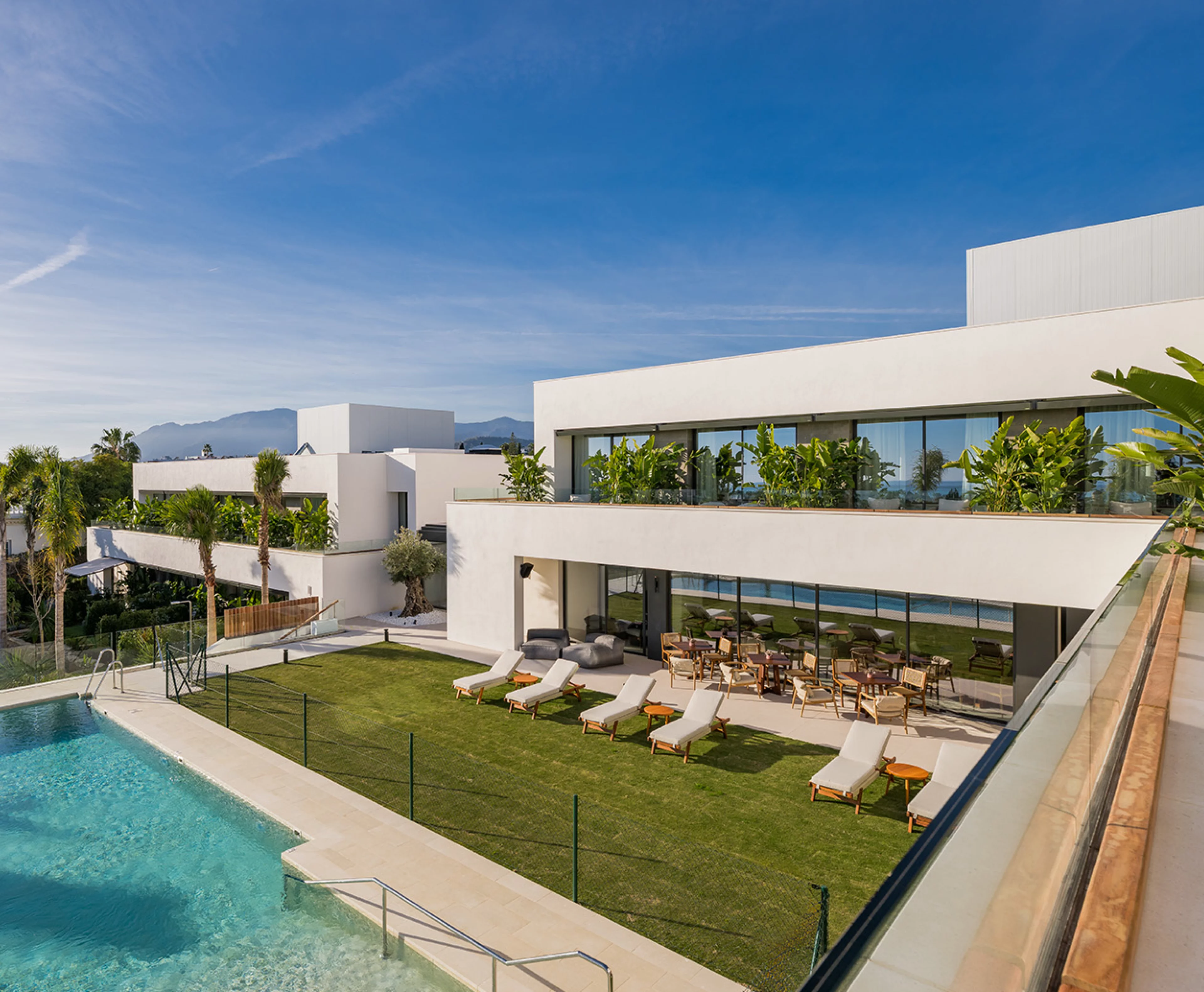 Exterior view of Naghoi recovery center with modern architecture, gardens, and pool designed for restful recovery.