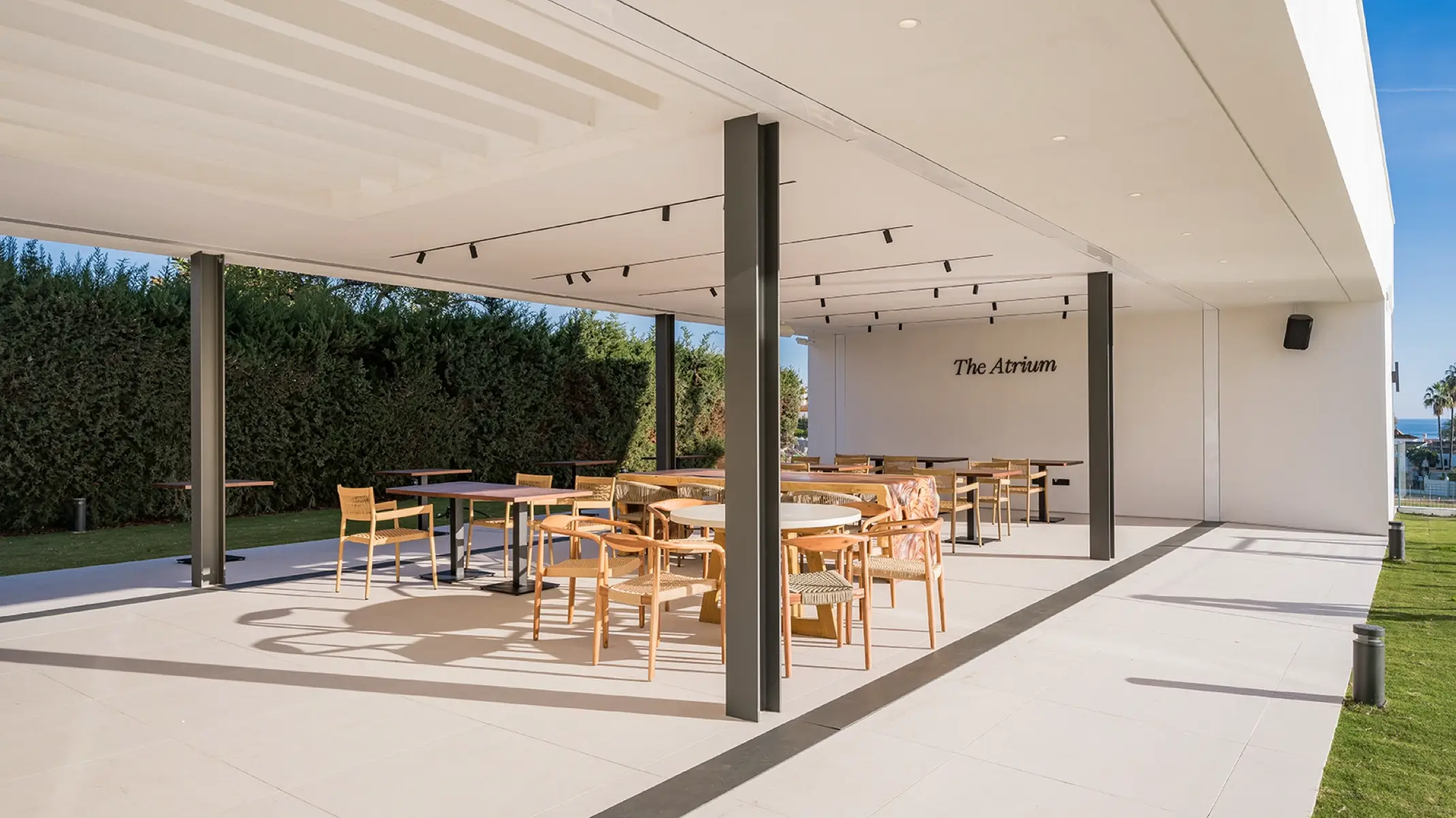 The Atrium at Naghoi — covered outdoor dining terrace with sea views, Costa del Sol post-operative recovery facility.